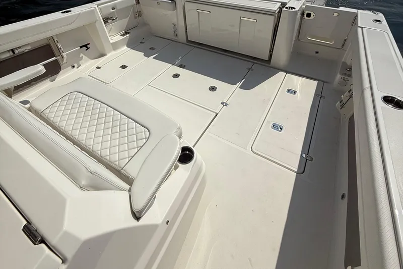 Oorah Yacht Photos Pics 2022 Pursuit S 378 Sport boat deck with cushioned seating and storage compartments.