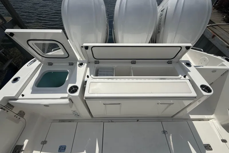Oorah Yacht Photos Pics 2022 Pursuit S 378 Sport boat deck with storage compartments and outboard engines.