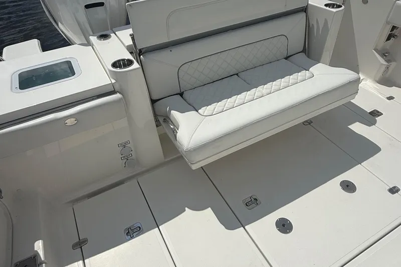 Oorah Yacht Photos Pics 2022 Pursuit S 378 Sport boat interior with white cushioned seating and cup holders.