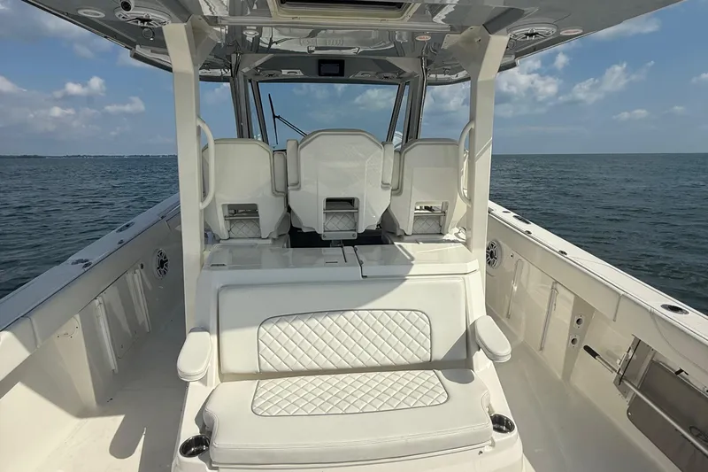 Oorah Yacht Photos Pics 2022 Pursuit S 378 Sport boat interior with white seating, ocean view.