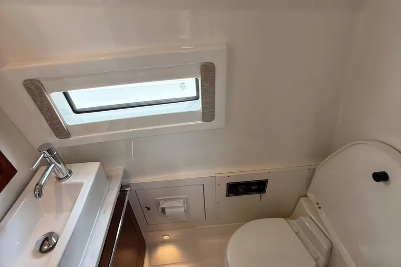 Oorah Yacht Photos Pics 2022 Pursuit S 378 Sport boat bathroom with sink, toilet, and window.