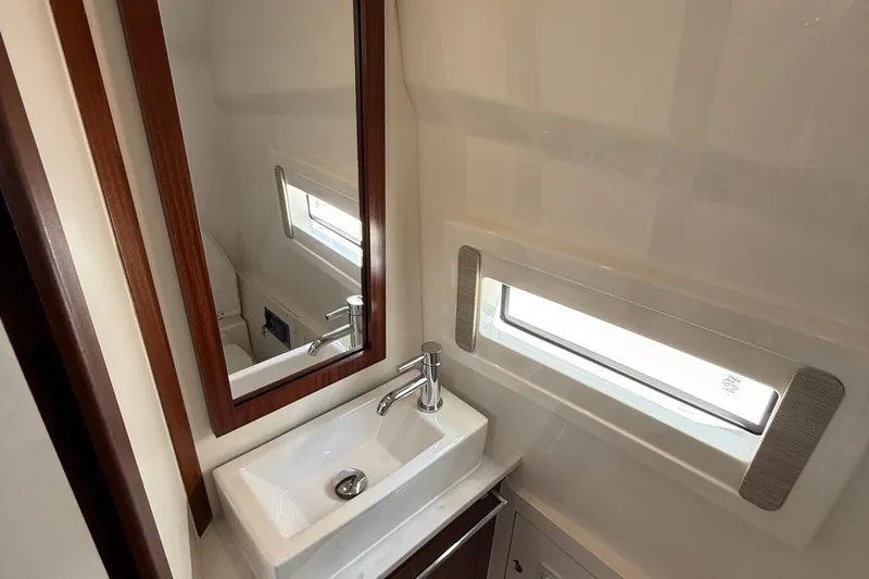 Oorah Yacht Photos Pics 2022 Pursuit S 378 Sport boat bathroom with modern sink and mirror.
