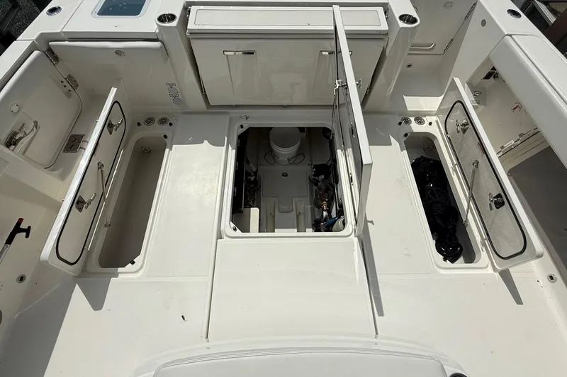 Oorah Yacht Photos Pics 2022 Pursuit S 378 Sport boat deck with open storage compartments and engine access.