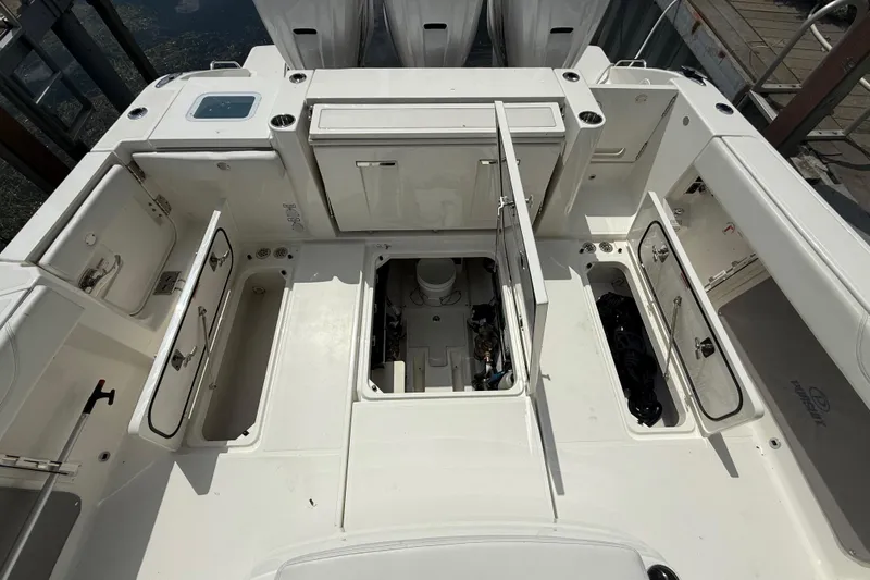 Oorah Yacht Photos Pics 2022 Pursuit S 378 Sport boat deck with open storage compartments and engine access.