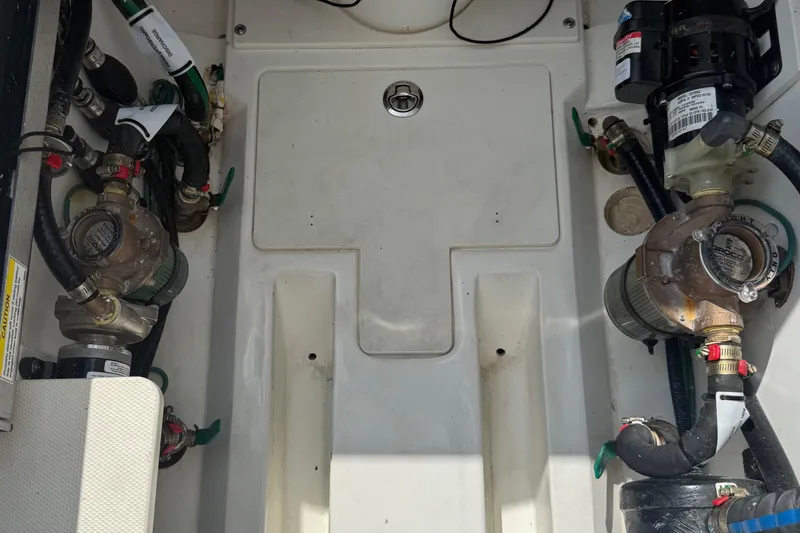 Oorah Yacht Photos Pics 2022 Pursuit S 378 Sport boat engine compartment with visible pumps and hoses.