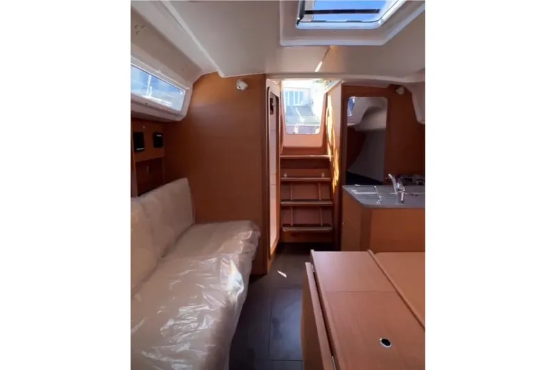  Yacht Photos Pics 2023 Dufour 32 yacht interior with wooden finish and modern design.