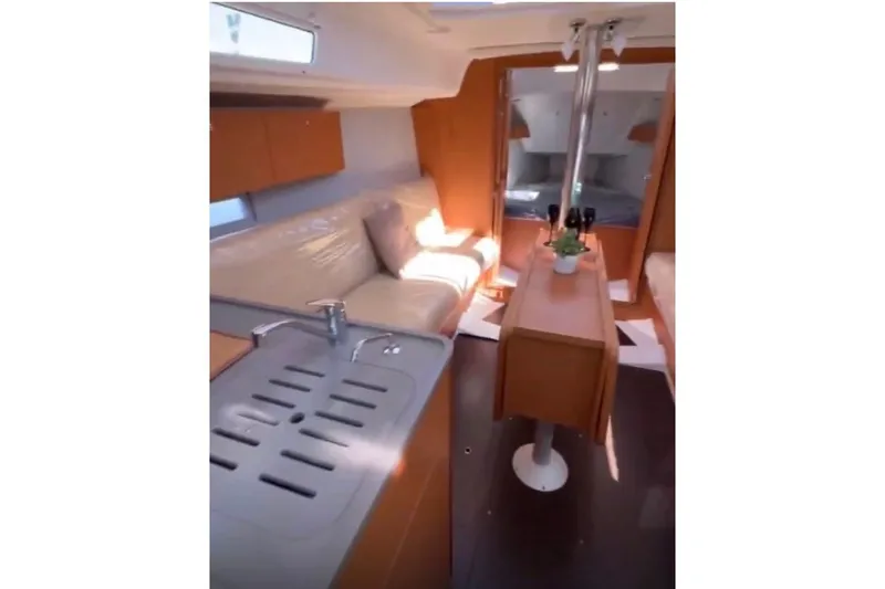  Yacht Photos Pics Interior of 2023 Dufour 32 yacht with modern kitchen and cozy seating area.