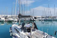 2023 Dufour 32 sailboat docked in a marina with clear blue skies.