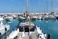 2023 Dufour 32 sailboat docked in a marina, surrounded by other boats.