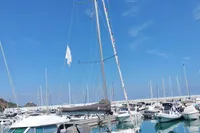 2023 Dufour 32 sailboat docked in a marina under a clear blue sky.