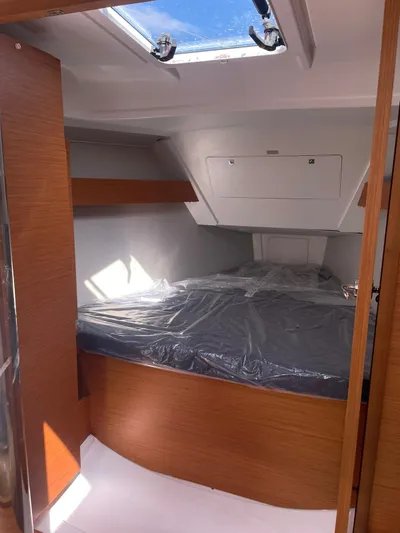  Yacht Photos Pics 2023 Dufour 32 yacht interior cabin with skylight and wooden finish.