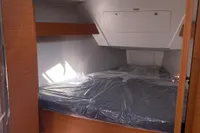 2023 Dufour 32 yacht interior cabin with skylight and wooden finish.