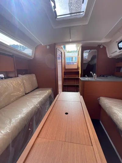  Yacht Photos Pics 2023 Dufour 32 yacht interior with cozy seating and modern kitchen area.