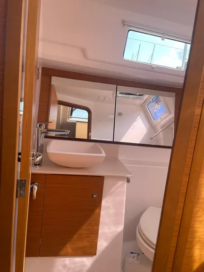  Yacht Photos Pics Modern bathroom interior of 2023 Dufour 32 yacht with sink and mirror.