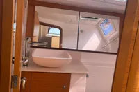 Modern bathroom interior of 2023 Dufour 32 yacht with sink and mirror.