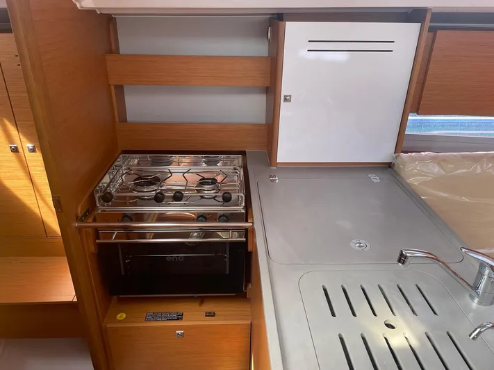  Yacht Photos Pics Modern kitchen area in 2023 Dufour 32 yacht with stove and sink.