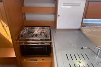 Modern kitchen area in 2023 Dufour 32 yacht with stove and sink.