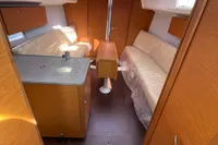Interior of 2023 Dufour 32 sailboat with modern wood finish and seating area.