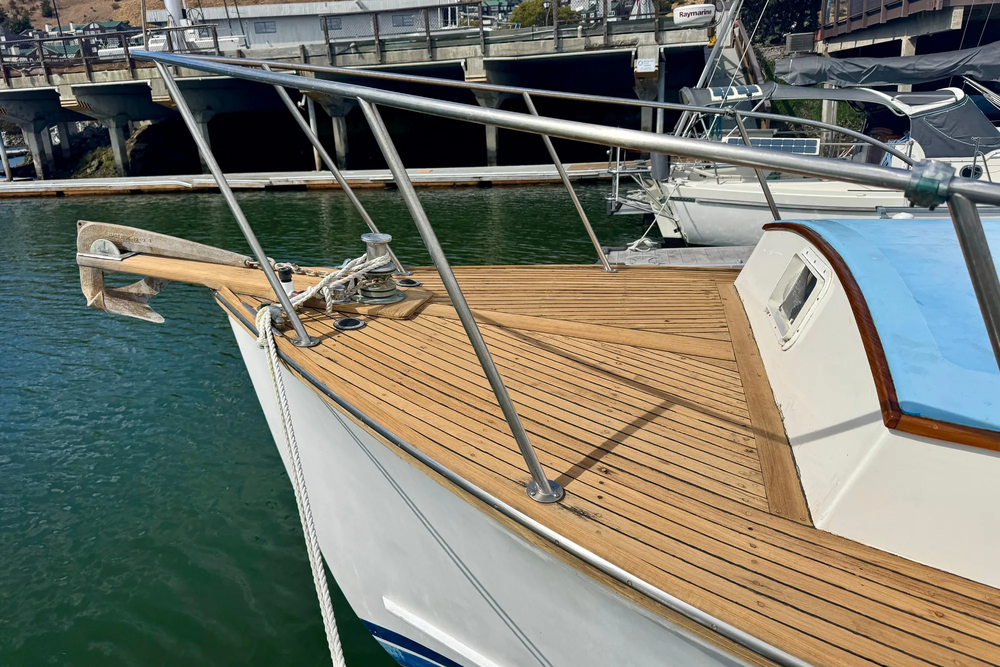 1982 Jarvis Newman Flybridge Cruiser with wooden deck, docked in a marina.