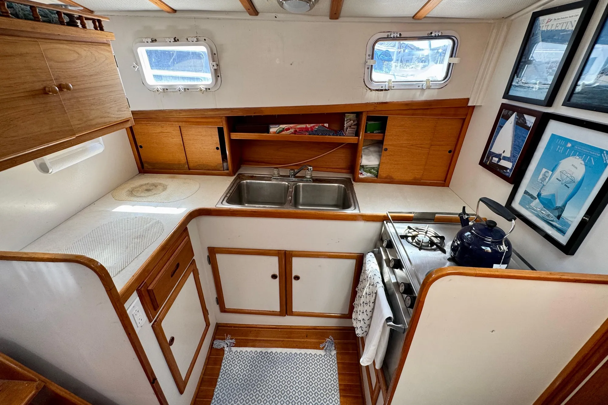 1982 Jarvis Newman Flybridge Cruiser kitchen with wood cabinets, stove, and sink.