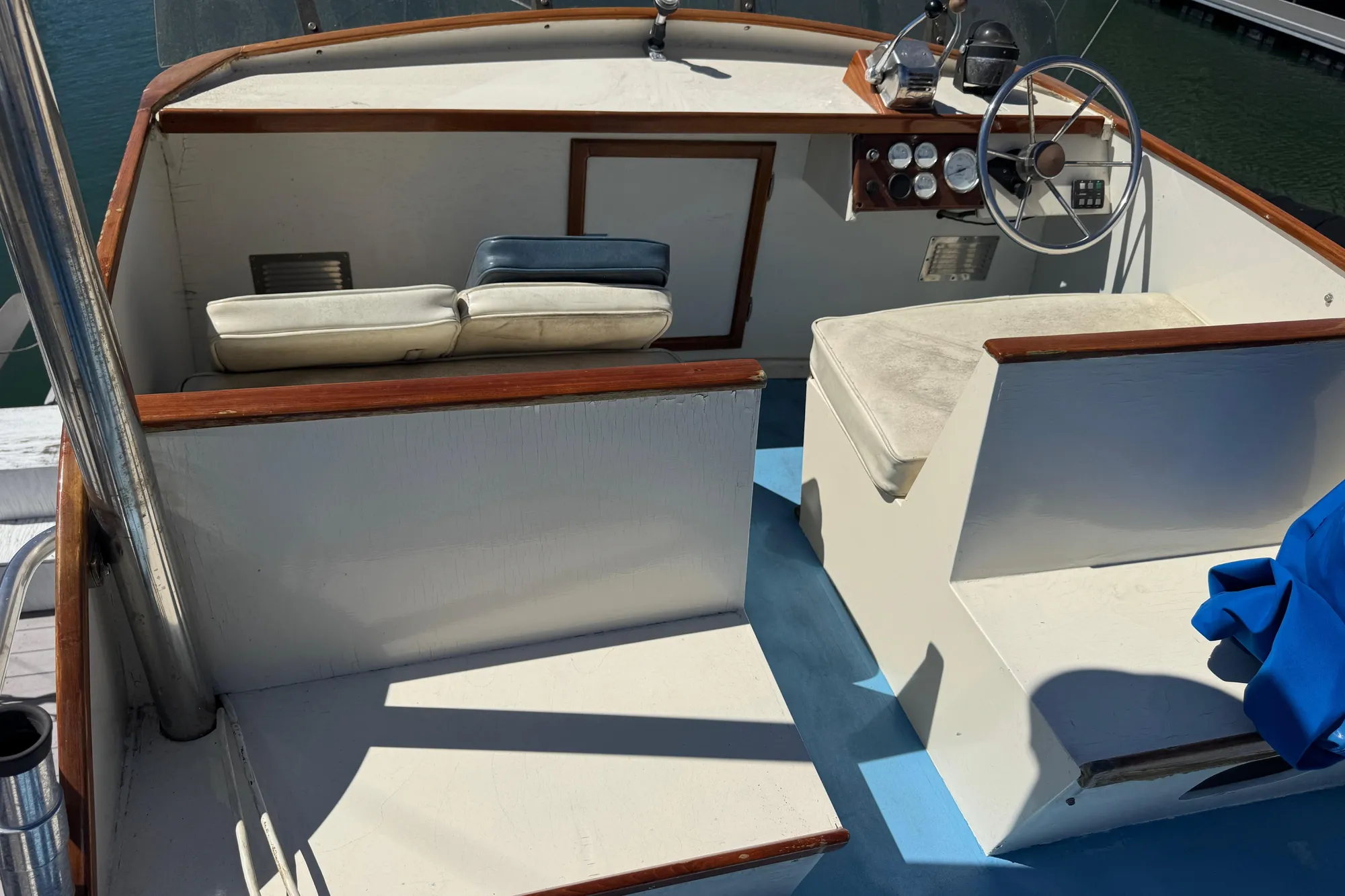 1982 Jarvis Newman Flybridge Cruiser helm with seating, steering wheel, and control panel.