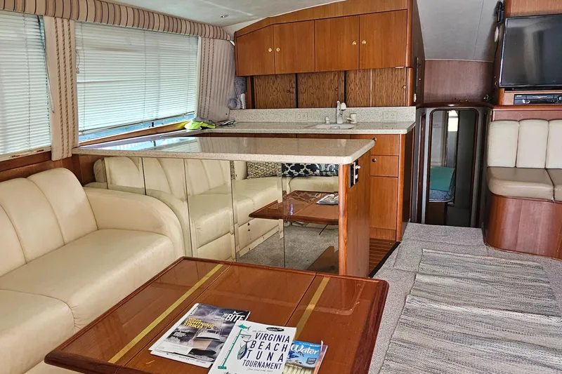  Yacht Photos Pics Interior of 1999 Ocean Yachts 48 Super Sport with beige seating and wooden cabinetry.