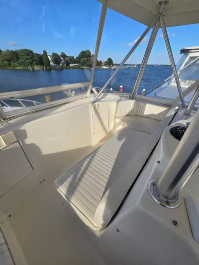  Yacht Photos Pics 1999 Ocean Yachts 48 Super Sport cockpit with seating, overlooking serene waters and blue sky.