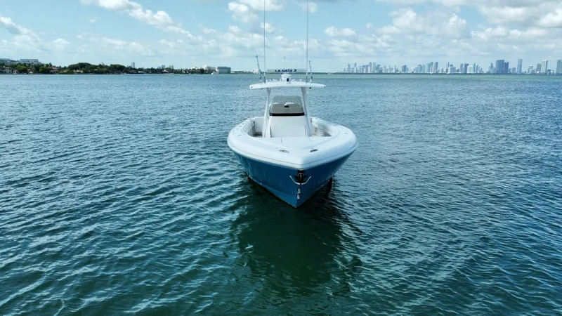 La Nata 3 Yacht Photos Pics 2015 Intrepid 375 Center Console boat on calm water with city skyline in background.