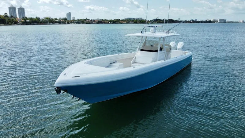 La Nata 3 Yacht Photos Pics 2015 Intrepid 375 Center Console boat on calm water, clear sky background.