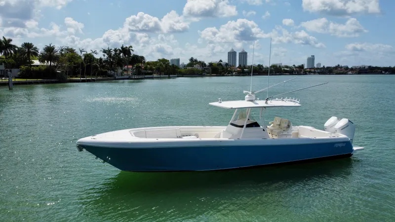 La Nata 3 Yacht Photos Pics 2015 Intrepid 375 Center Console boat on calm water under a partly cloudy sky.