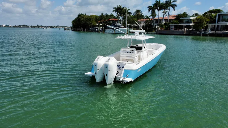 La Nata 3 Yacht Photos Pics 2015 Intrepid 375 Center Console boat on calm water near waterfront homes.