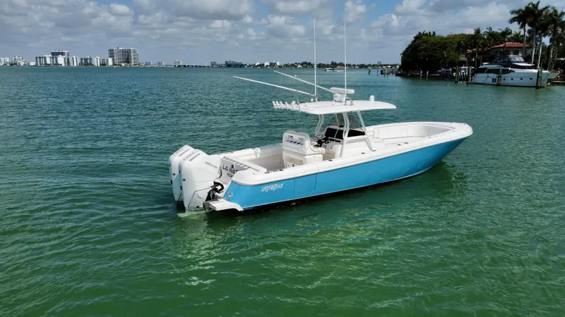 La Nata 3 Yacht Photos Pics 2015 Intrepid 375 Center Console boat on calm water, clear sky, coastal background.
