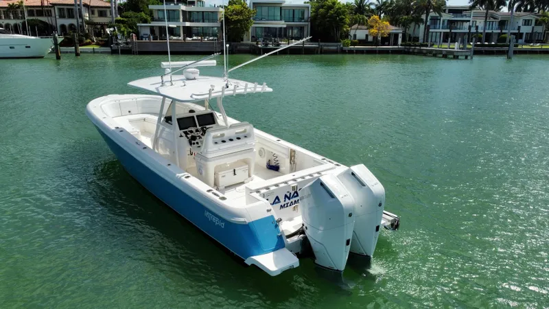 La Nata 3 Yacht Photos Pics 2015 Intrepid 375 Center Console boat on calm water near luxury waterfront homes.