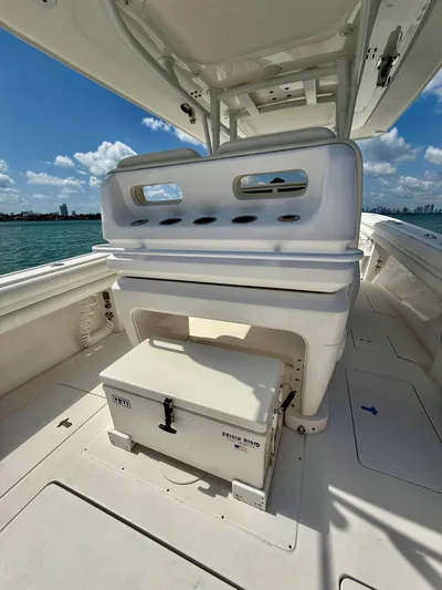 La Nata 3 Yacht Photos Pics 2015 Intrepid 375 Center Console boat interior with seating and storage, under a clear blue sky.