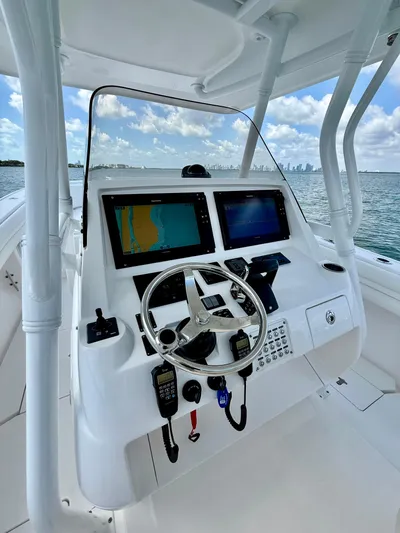 La Nata 3 Yacht Photos Pics 2015 Intrepid 375 Center Console boat helm with dual navigation screens and steering wheel.