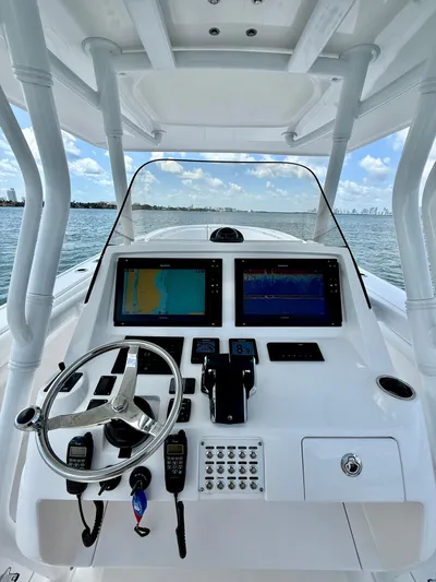 La Nata 3 Yacht Photos Pics 2015 Intrepid 375 Center Console boat dashboard with navigation screens and steering wheel.