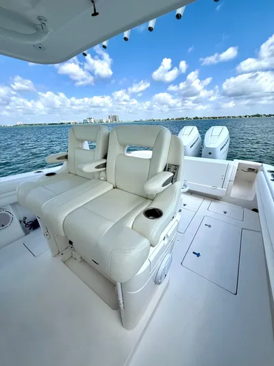 La Nata 3 Yacht Photos Pics 2015 Intrepid 375 Center Console boat with plush seating, ocean view, and clear blue sky.