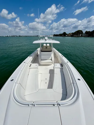 La Nata 3 Yacht Photos Pics 2015 Intrepid 375 Center Console boat on calm water under a partly cloudy sky.