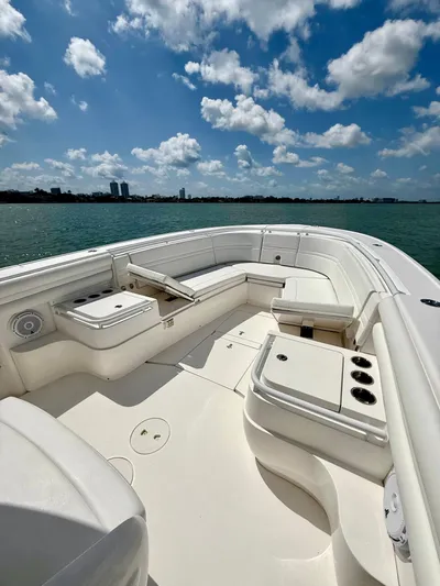 La Nata 3 Yacht Photos Pics 2015 Intrepid 375 Center Console boat with spacious seating, under a bright blue sky.