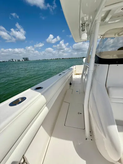 La Nata 3 Yacht Photos Pics 2015 Intrepid 375 Center Console boat on calm water under a clear blue sky.