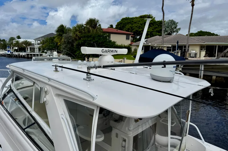 Tekeze Yacht Photos Pics 2019 Intrepid 475 Sport Yacht with Garmin equipment, docked near waterfront homes.