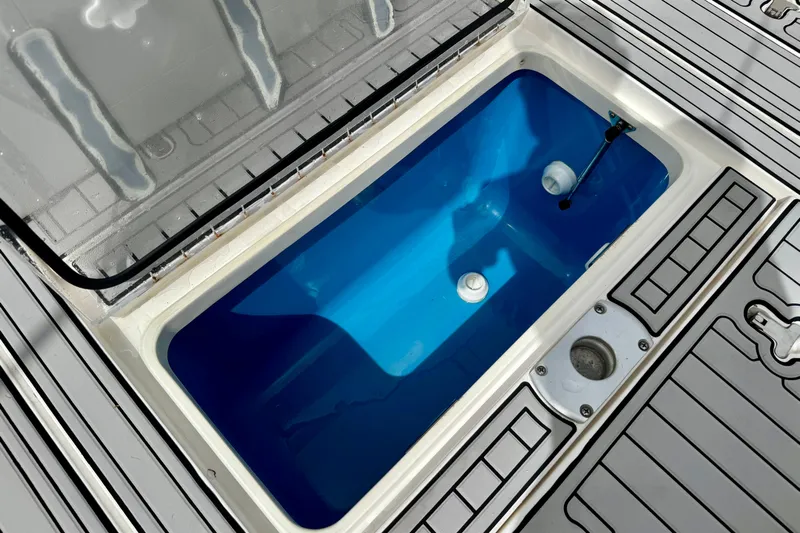 Tekeze Yacht Photos Pics Open storage compartment on 2019 Intrepid 475 Sport Yacht with blue interior.