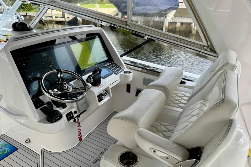 Tekeze Yacht Photos Pics 2019 Intrepid 475 Sport Yacht helm with advanced navigation displays and luxurious seating.