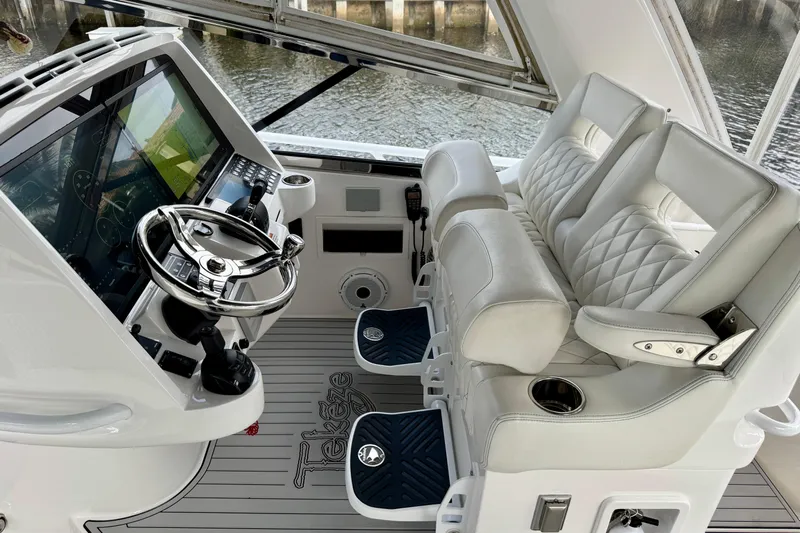 Tekeze Yacht Photos Pics 2019 Intrepid 475 Sport Yacht helm with luxurious seating and advanced navigation controls.