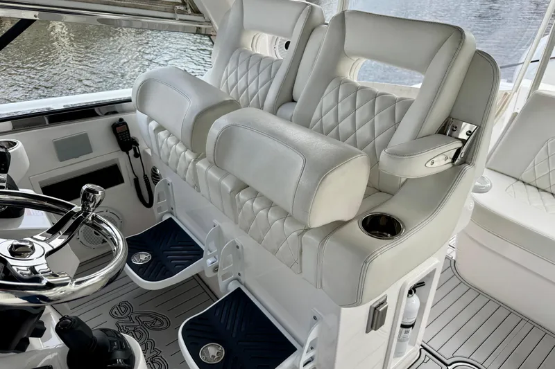 Tekeze Yacht Photos Pics Luxurious helm seating on 2019 Intrepid 475 Sport Yacht with quilted upholstery and chrome accents.
