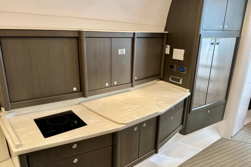 Tekeze Yacht Photos Pics Luxurious kitchen area in 2019 Intrepid 475 Sport Yacht with modern cabinetry and appliances.