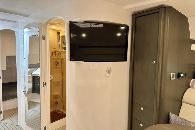 Tekeze Yacht Photos Pics Interior of 2019 Intrepid 475 Sport Yacht featuring TV, shower, and modern cabinetry.