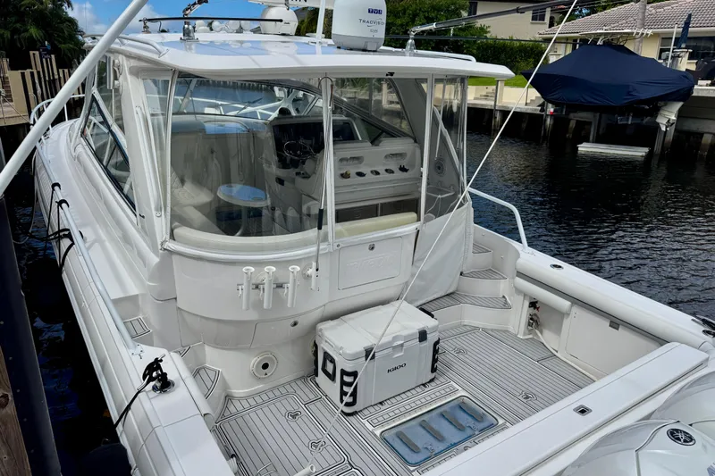 Tekeze Yacht Photos Pics 2019 Intrepid 475 Sport Yacht docked, showcasing spacious deck and sleek design.