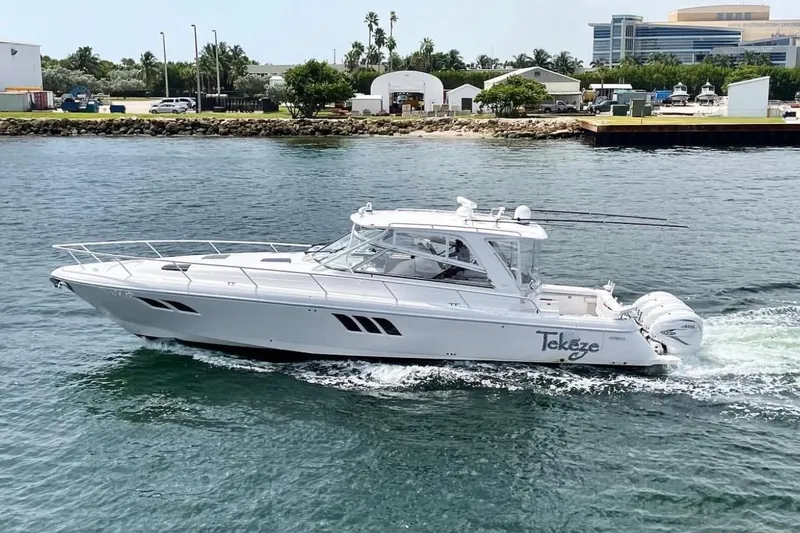 Tekeze Yacht Photos Pics 2019 Intrepid 475 Sport Yacht cruising on water near a coastal area.