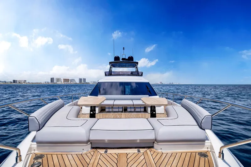 Yacht Photos Pics Luxurious 2022 Ferretti Yachts 670 on open sea with city skyline.
